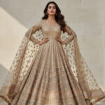 Indian woman wearing a luxury outfit in neutral tones, modern Indian fashion editorial style